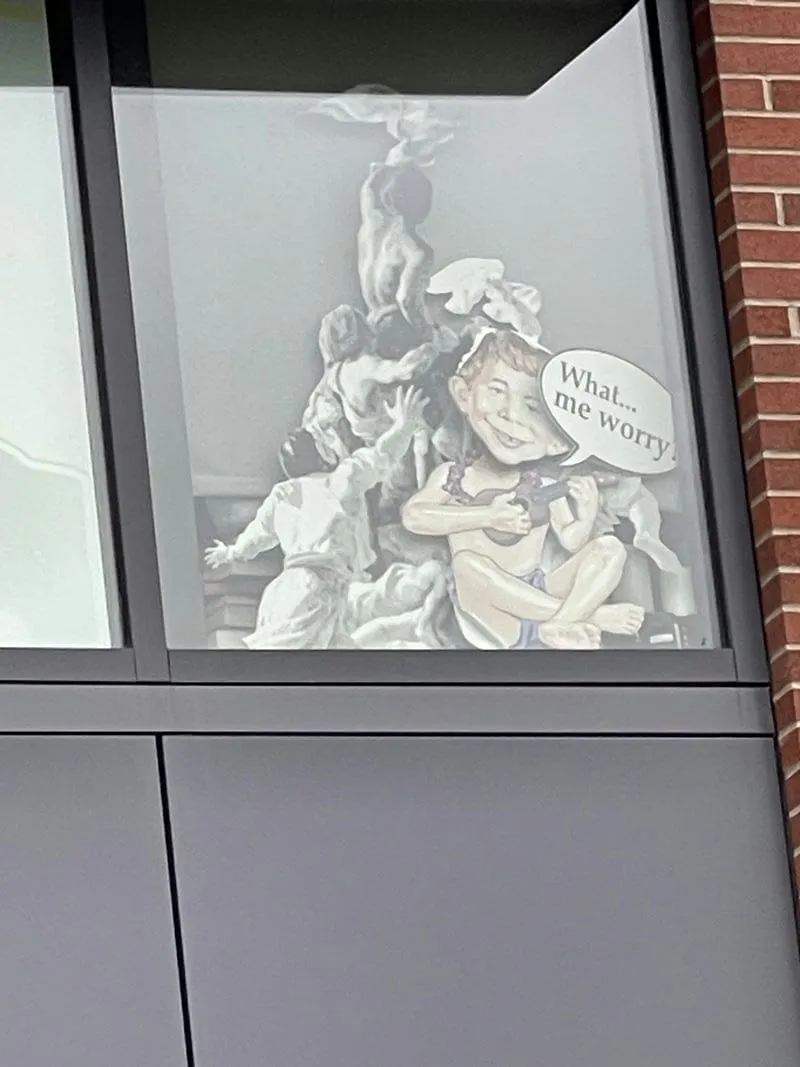art in a window at olympic college featuring Alfred e. Neuman