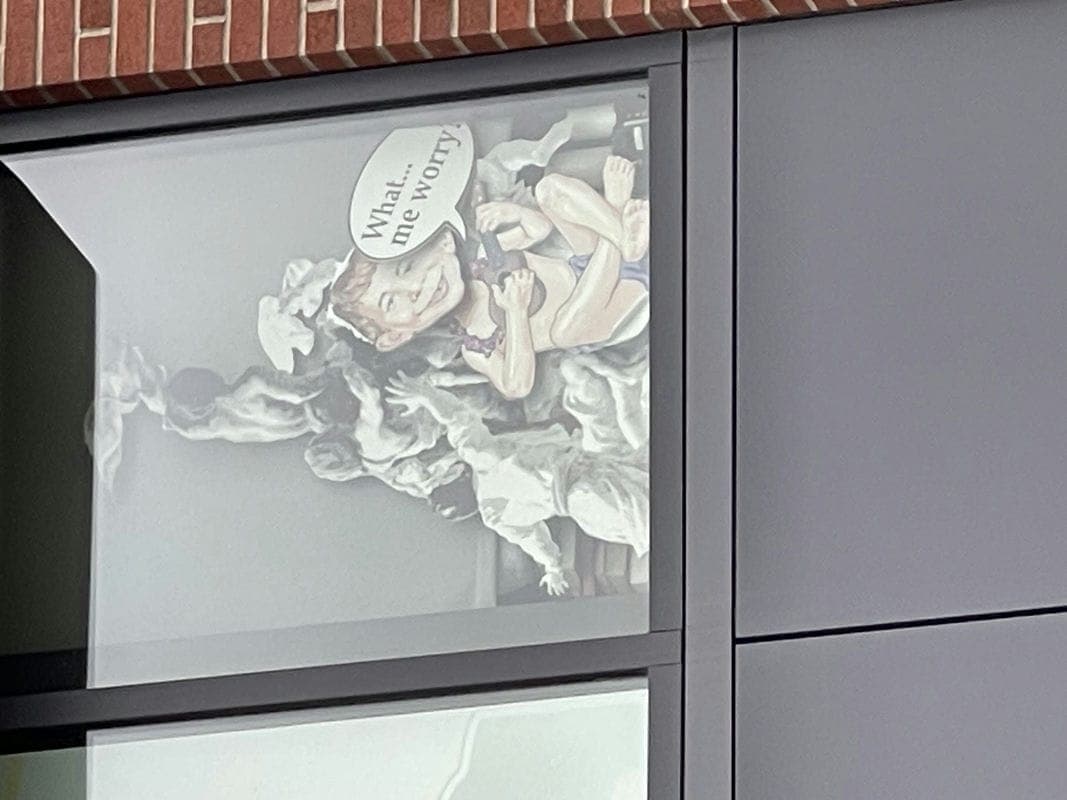 art in a window at olympic college featuring Alfred e. Neuman